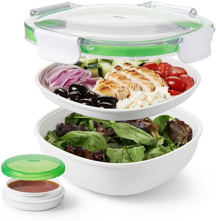 The white container, featuring a clear lid and a toppings tray that sits on top of the main bowl
