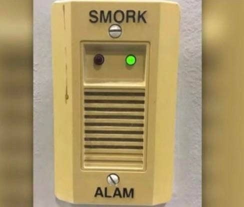 Smoke alarm reading "smork alam"