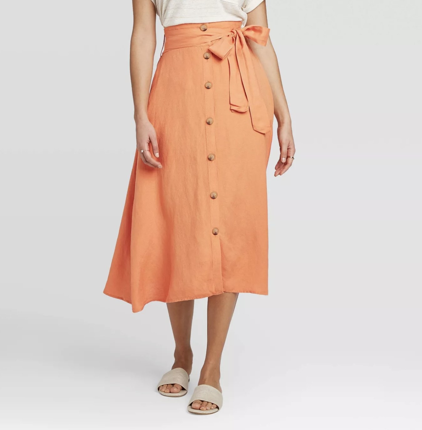 Model wearing the belted, button-down midi skirt