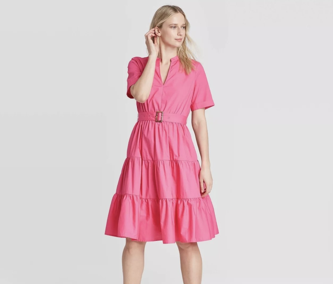 Model in the ruffled, short-sleeve pink dress