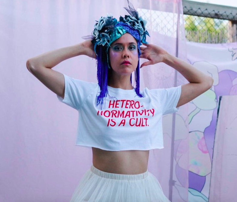 A model wearing the cropped tee that says &quot;Hetero-normativity is a cult&quot;