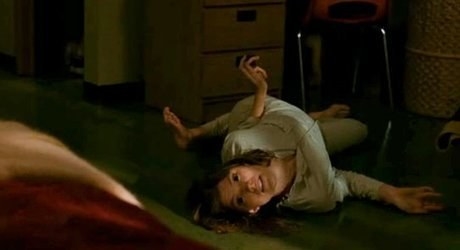 Actor Jennifer Carpenter laying with her body contorted on the floor as she&#x27;s being possessed.