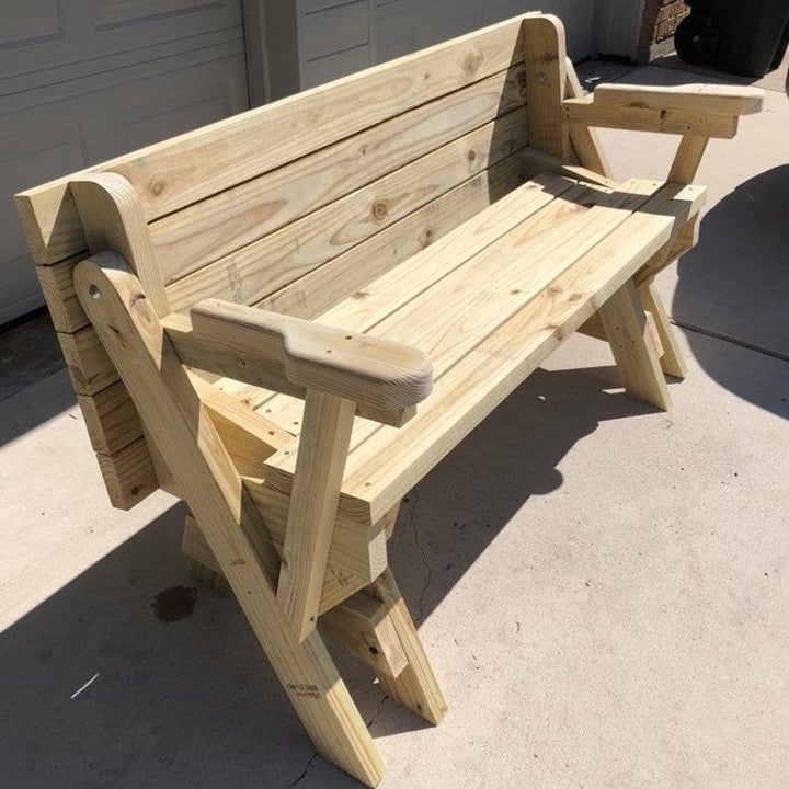 The same table converted back into a bench with the table folded behind it