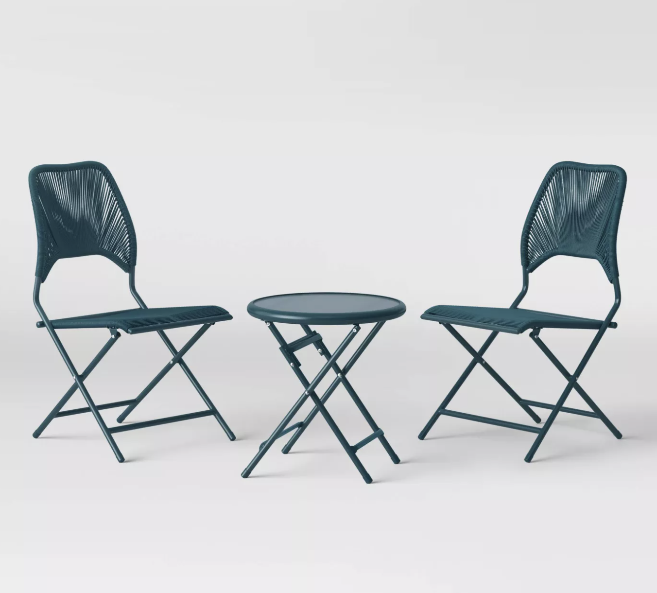 two teal folding chairs and matching small round table