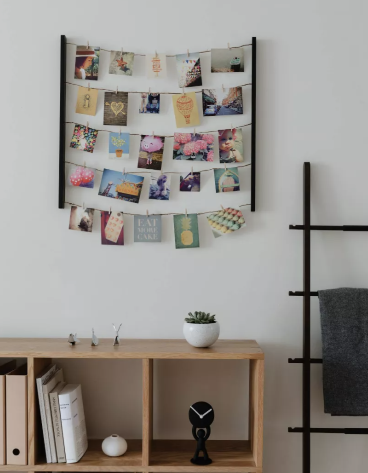 photos hung up on a bunch of lines with clips