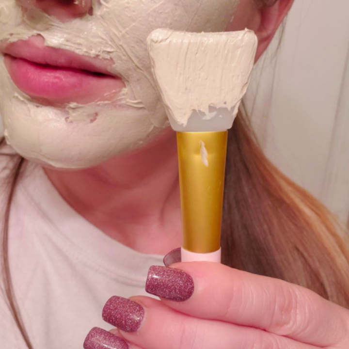 Reviewer uses same brush to apply a face mask on their face
