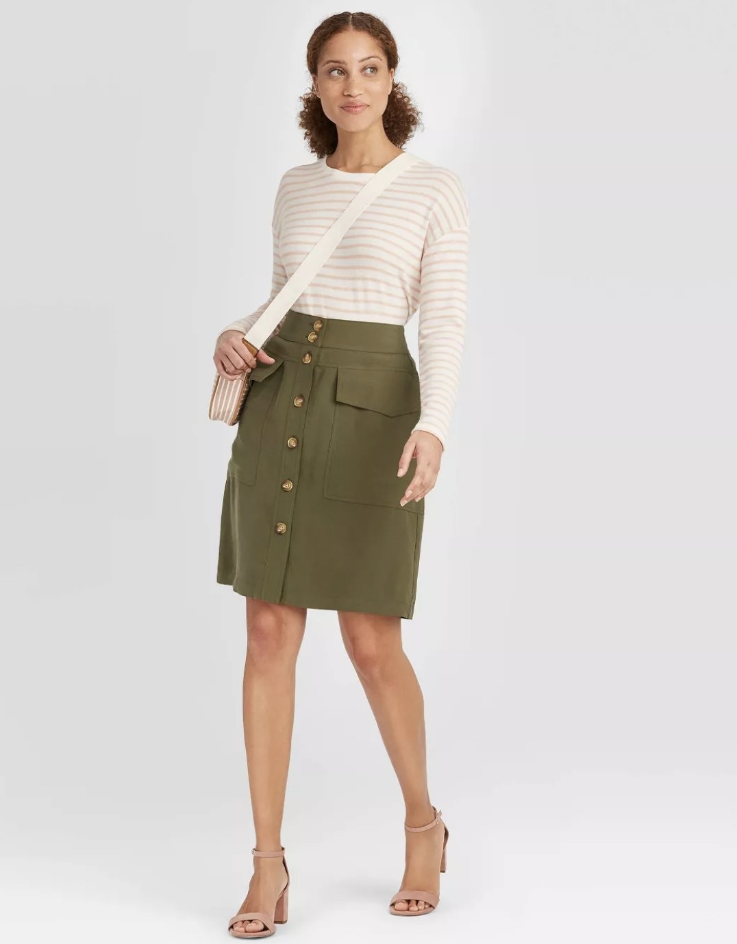 Model wearing the olive green button-down skirt