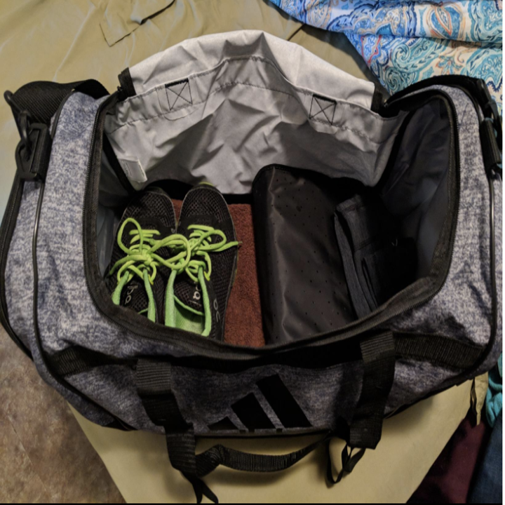Reviewer image of the bag's interior showing it has room for shoes, workout clothes, and more 