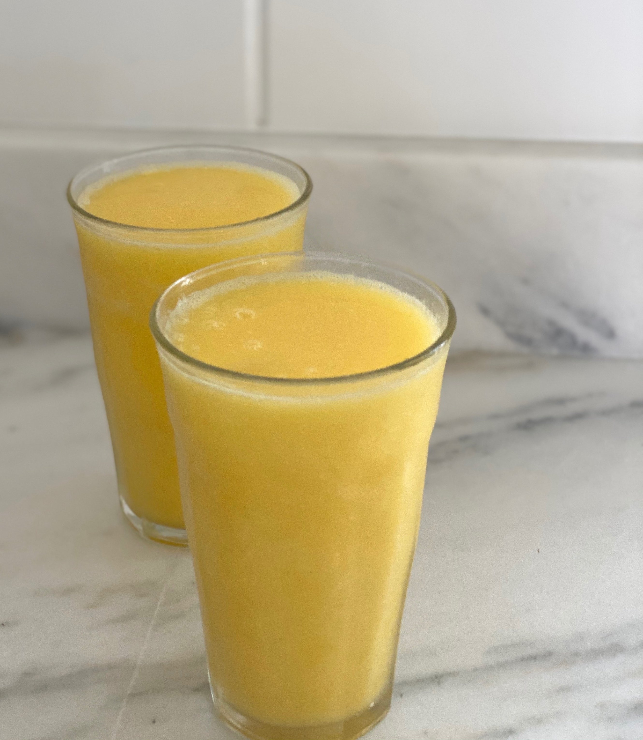 Two glasses of the mango White Claw slushy.