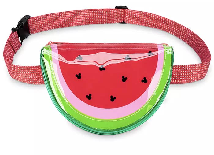 a watermelon shaped fanny pack with black mickey outlines as seeds
