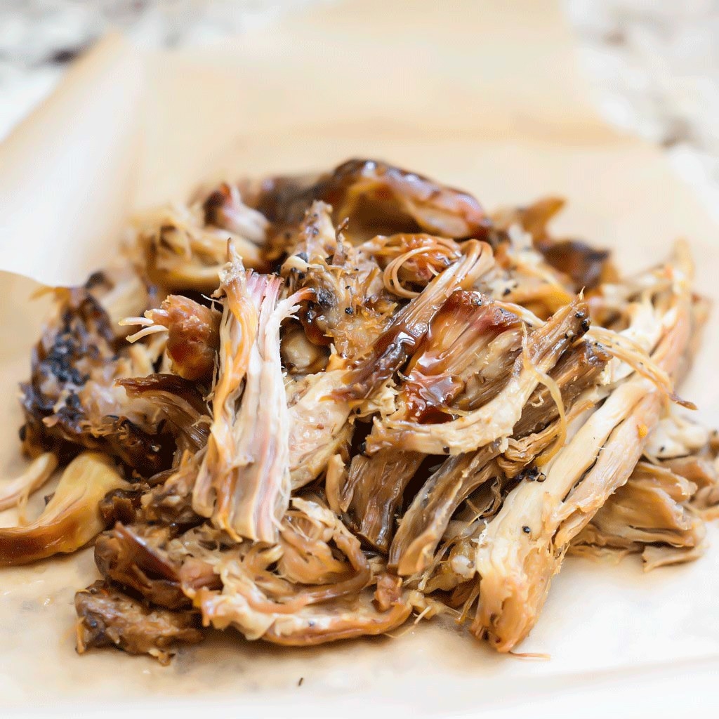 Shredded, sauce-drizzled pulled pork