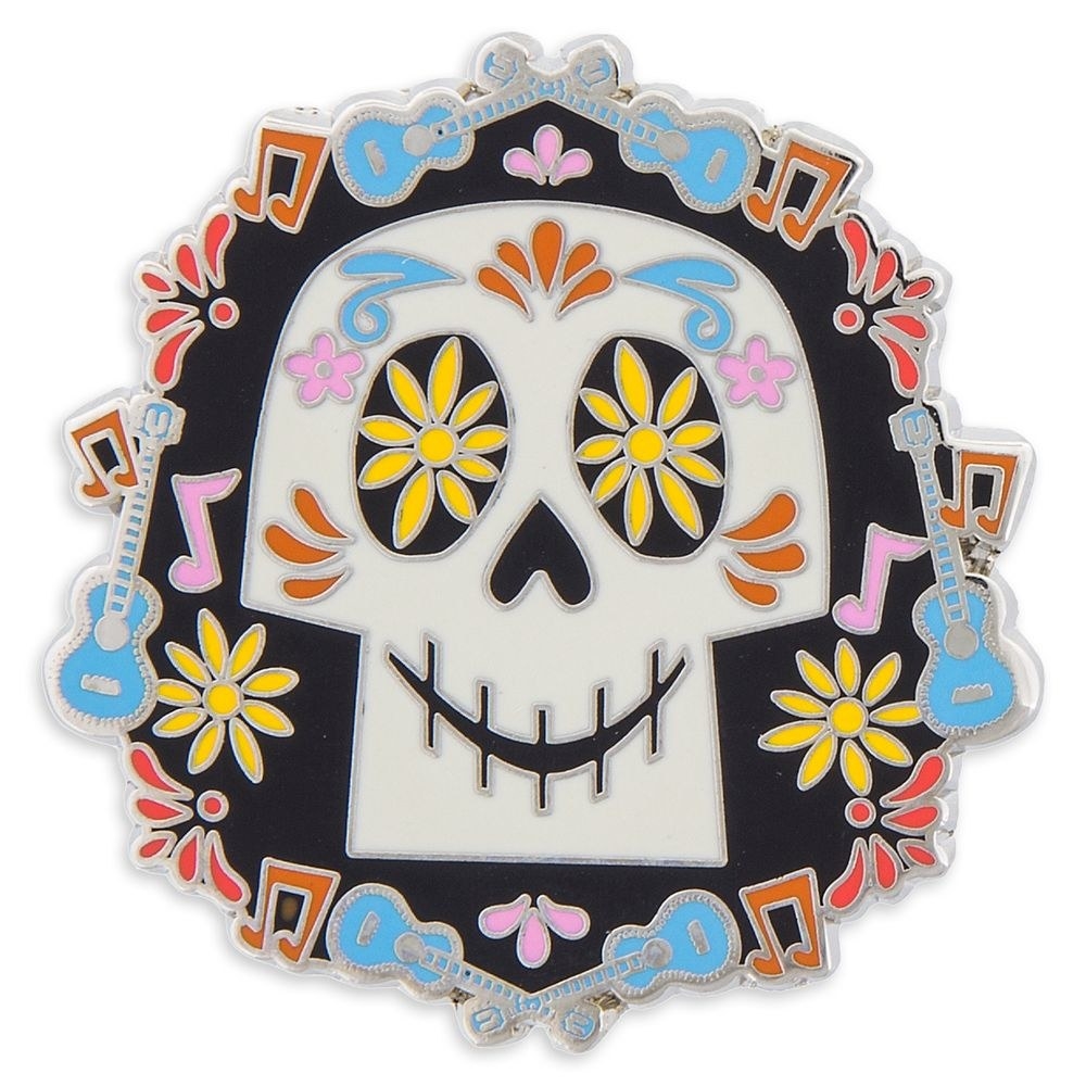 The pin, featuring the skull in the center surrounded by flowers, guitars, and music notes