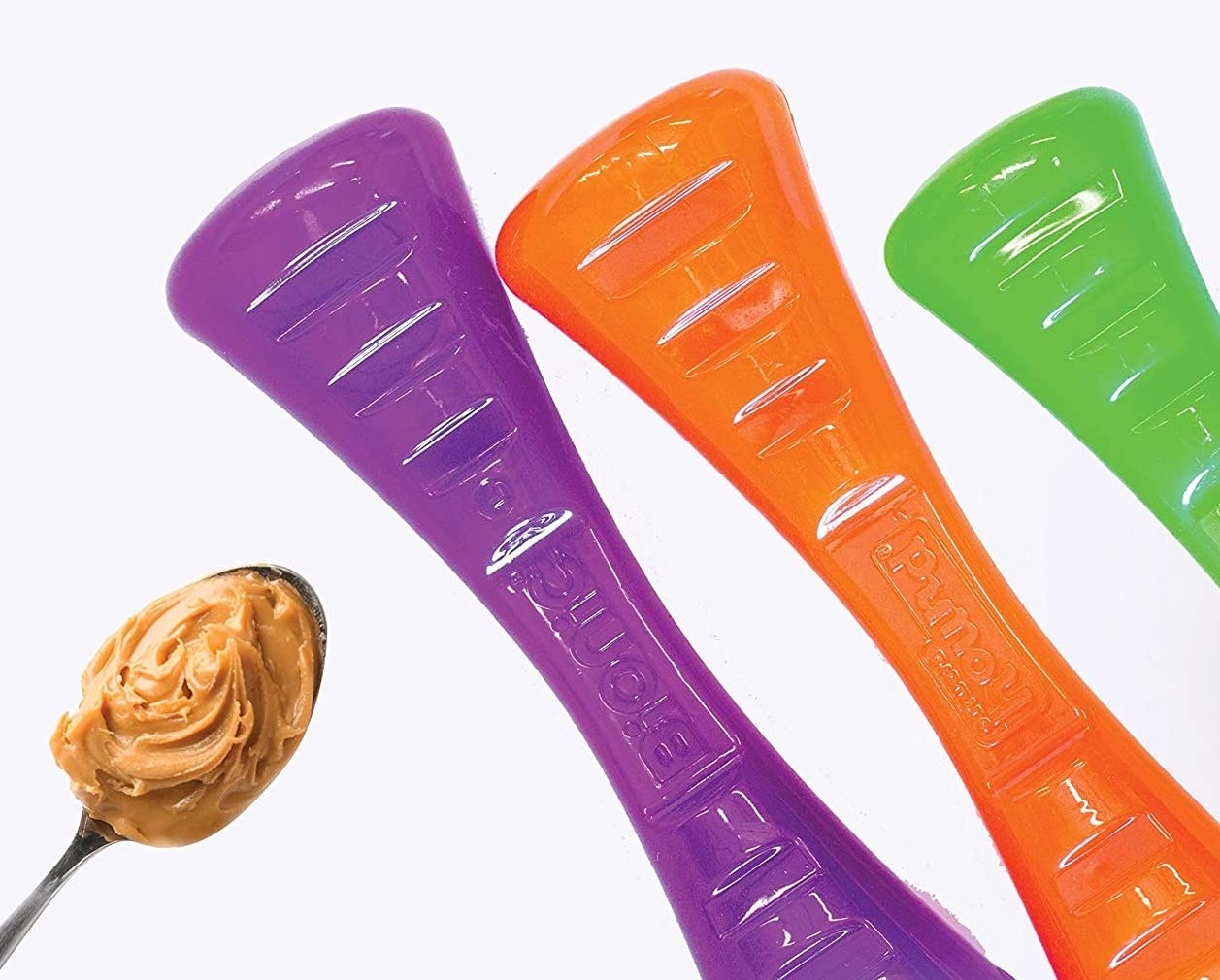 three of the rubberized looking throwing sticks in purple, orange, and green