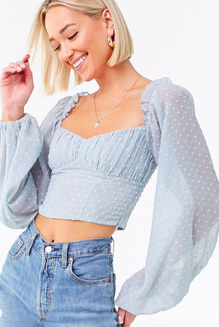 Model wears light blue clip dot crop top with high-rise jeans