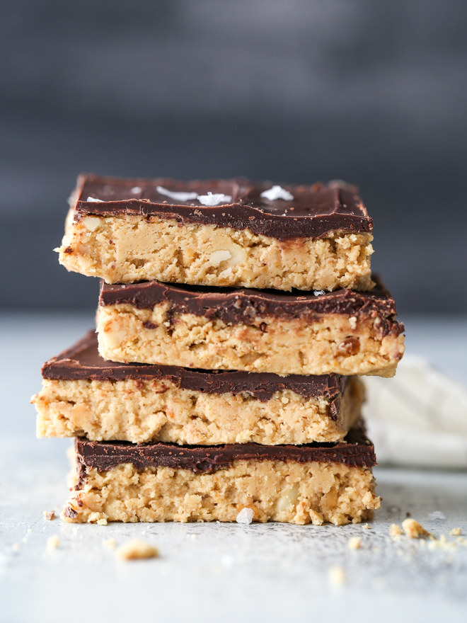A stack of peanut butter chocolate bars with salt sprinkled on top