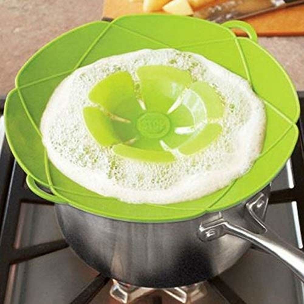 The splatter guard kept on a vessel of boiling milk to prevent overflow.