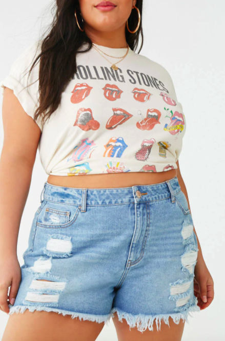 Model wears Rolling Stone tee shirt with blue distressed denim shorts