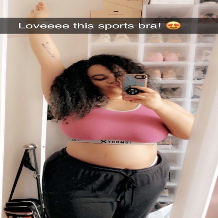 BuzzFeed Shopping editor wearing the sports bra in pink 