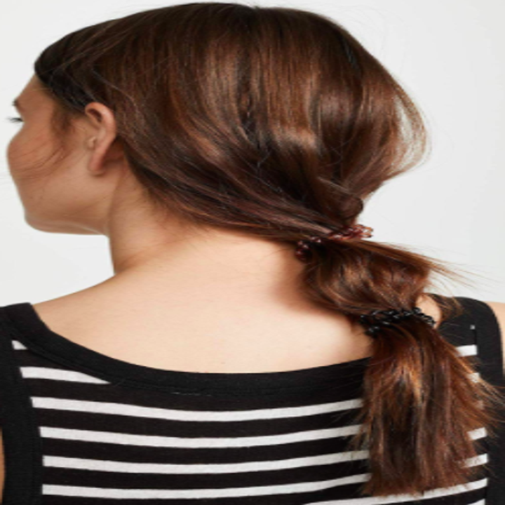 Model wears brown spiral hair ties in a long ponytail