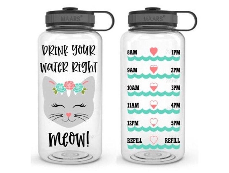 A water bottle with a cat on it that says "Drink your water right meow" on one side and lines on the other of how much water you should drink each hour