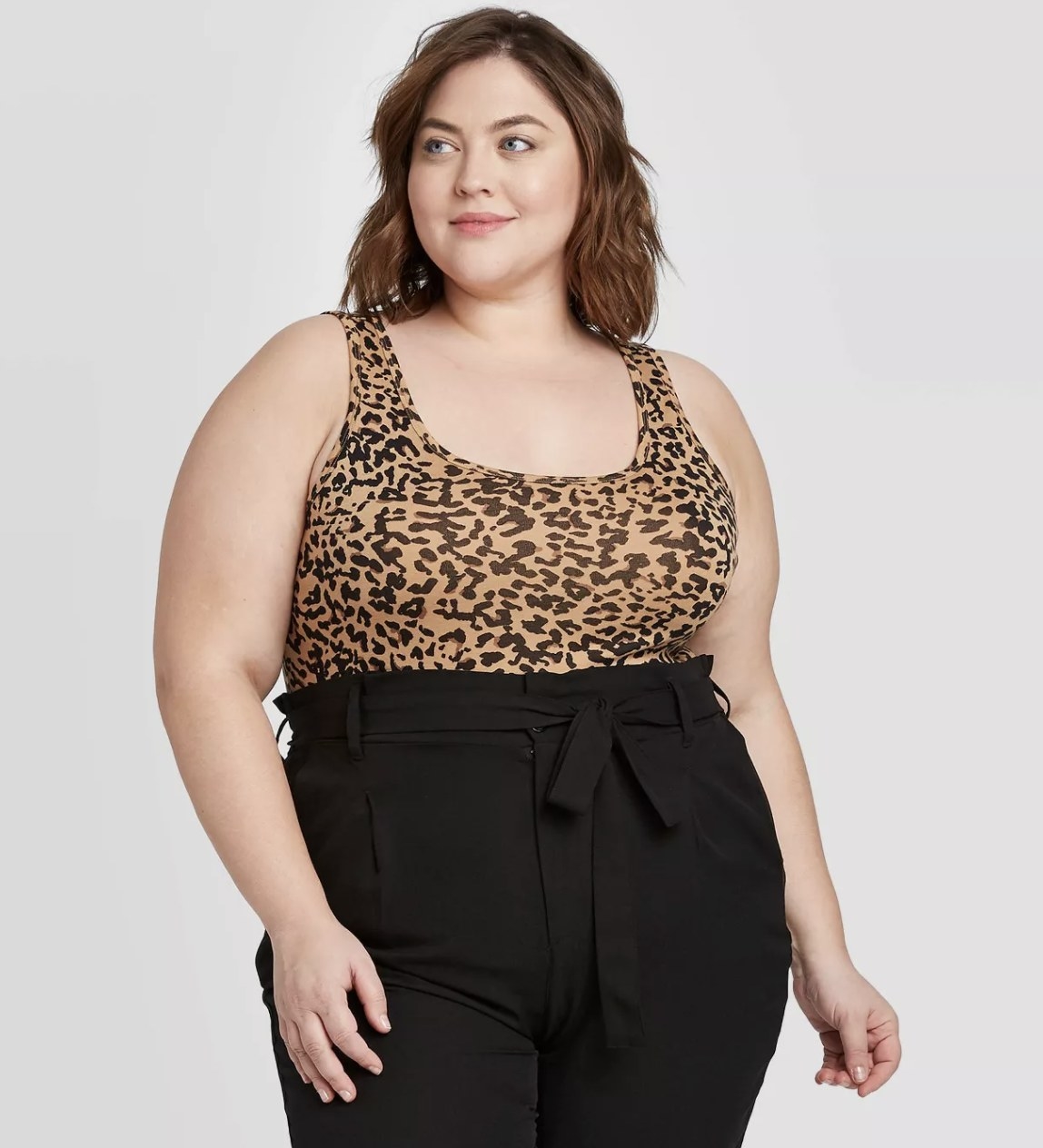 Model wearing the leopard tank with black pants 