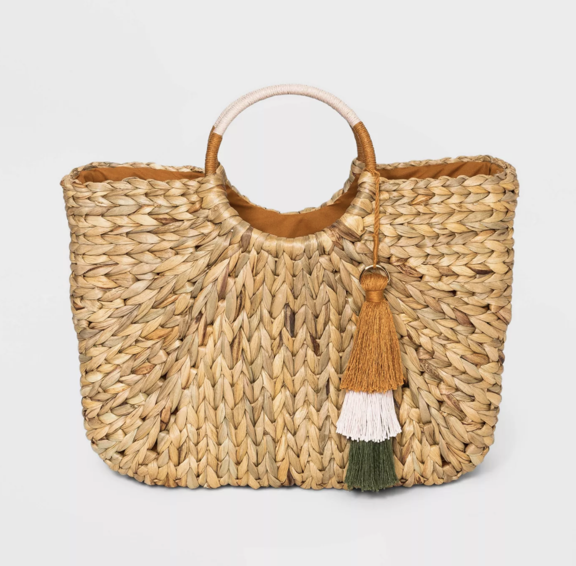 The straw tote with circle handles and a decorative tassel 