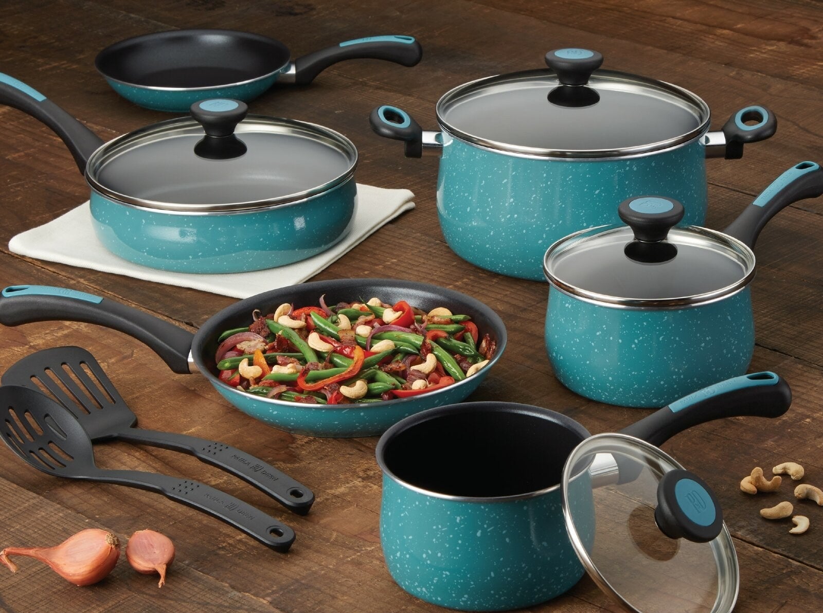 The cookware set in teal with speckled porcelain exterior