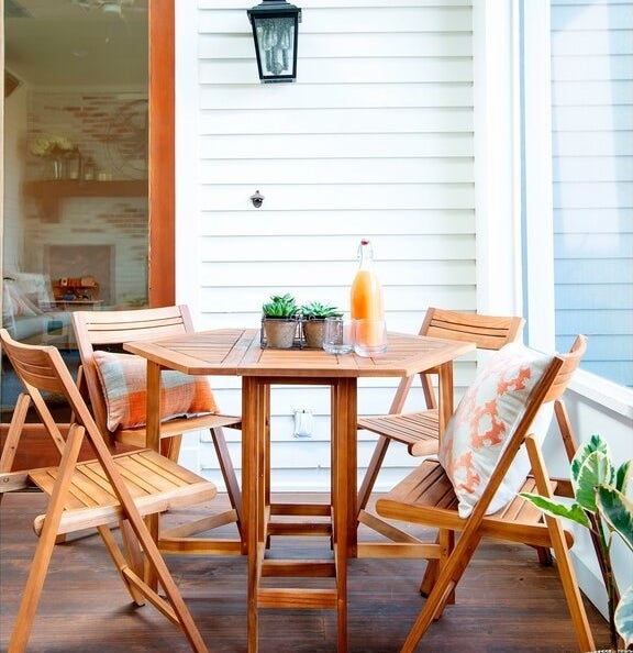 The hexagonal wooden table and matching folding chairs