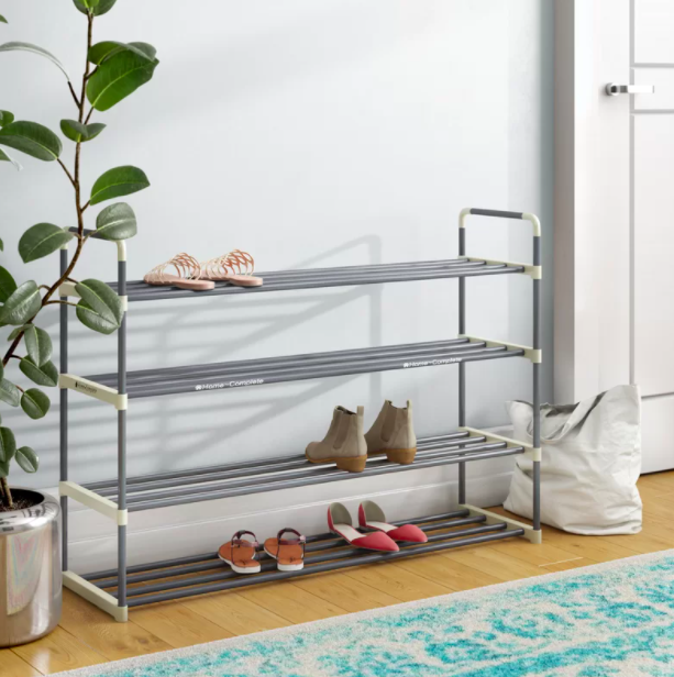 A silver four-tier shoe rack with sandals, boots, and flats