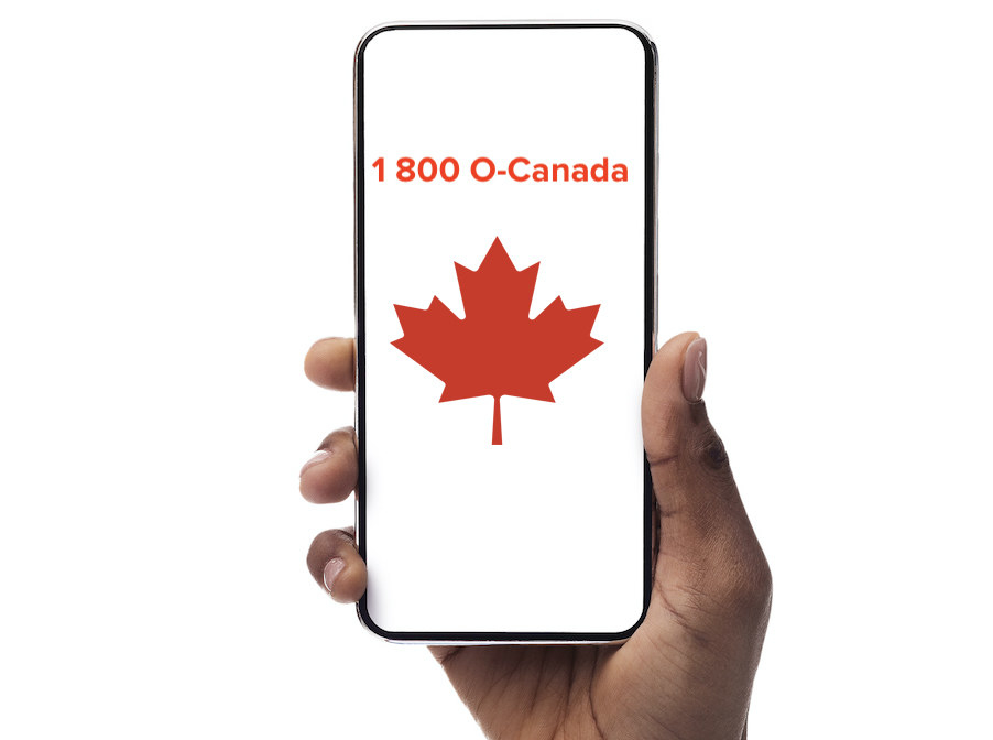 Over a white background, a hand holds an iPhone. The iPhone screen reads, "1-800-O-Canada" and an image of a red maple leaf sits below it.