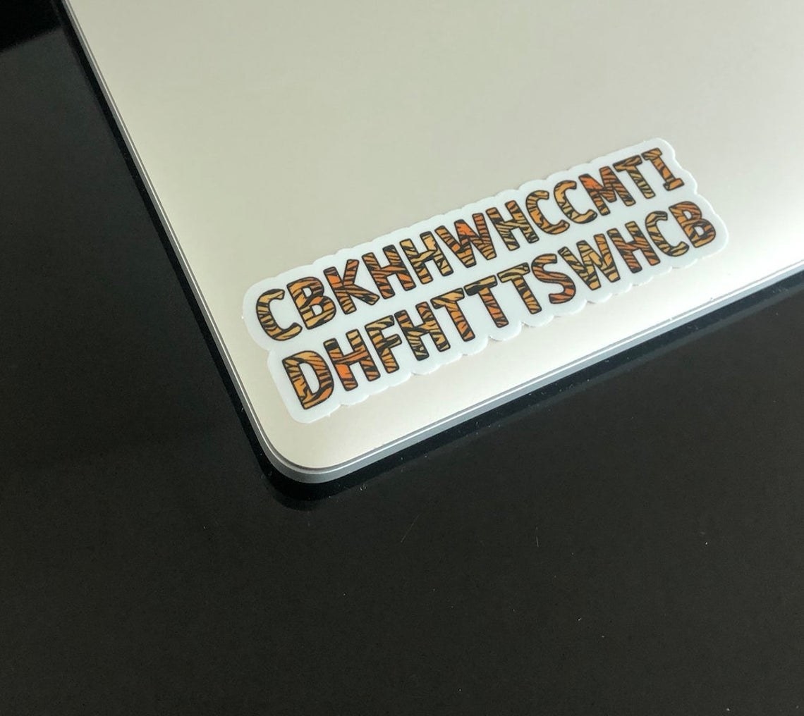 The CBKHHWHCCMTIDHFHTTTSWHCB waterproof sticker stuck to a laptop.