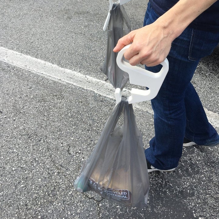 A person using the handles to carry bags. 
