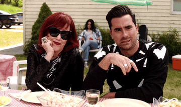 Moira and David Rose eating outside in an episode of &quot;Schitt&#x27;s Creek.&quot;