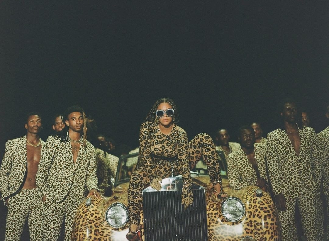 beyoncé crouching on a car in all leopard print