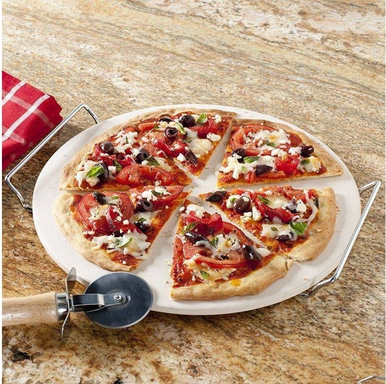 a white pizza stone with silver handles
