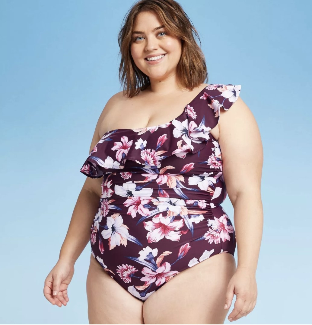 The swimsuit in dark purple with a floral print 