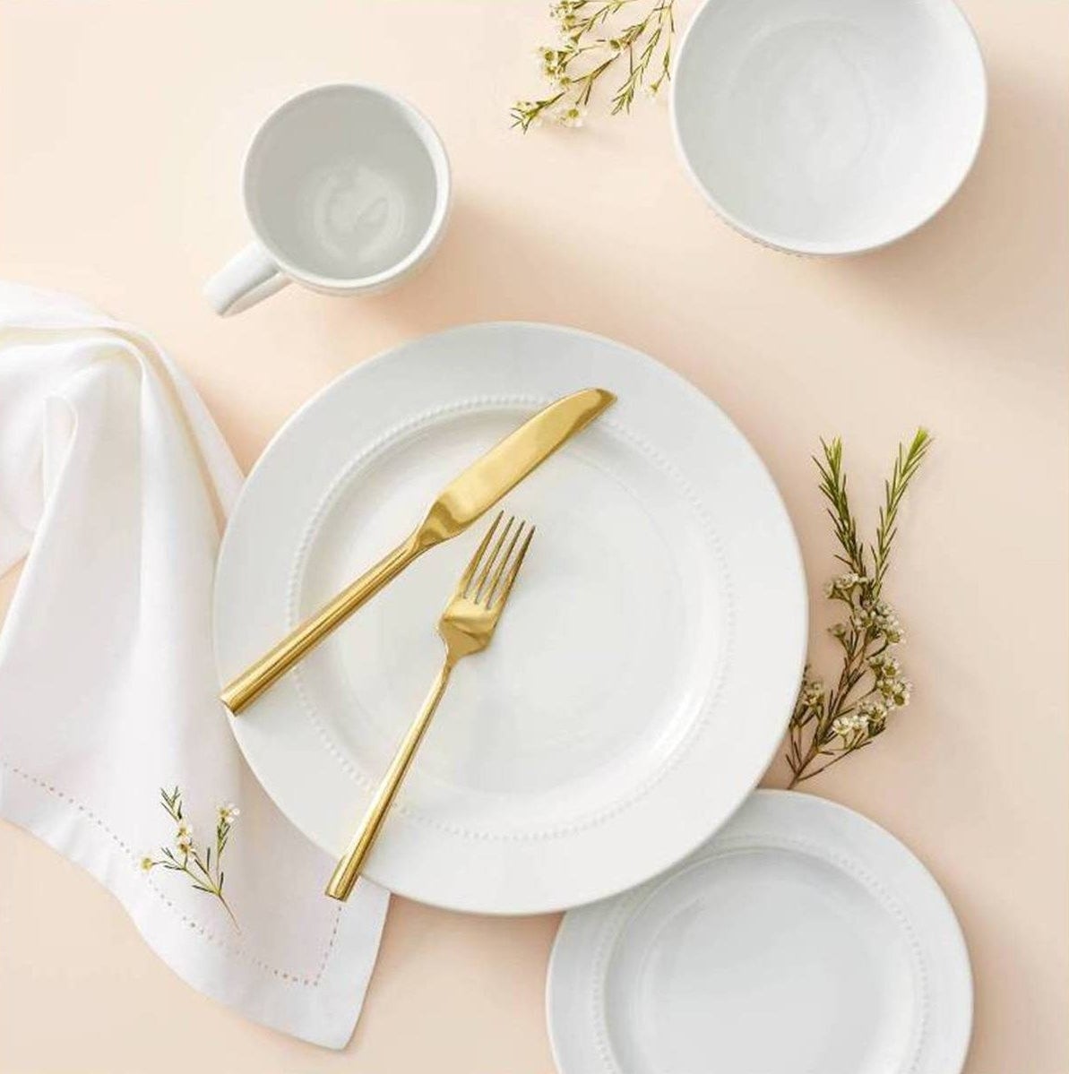 all white dinnerware with delicate beaded rims