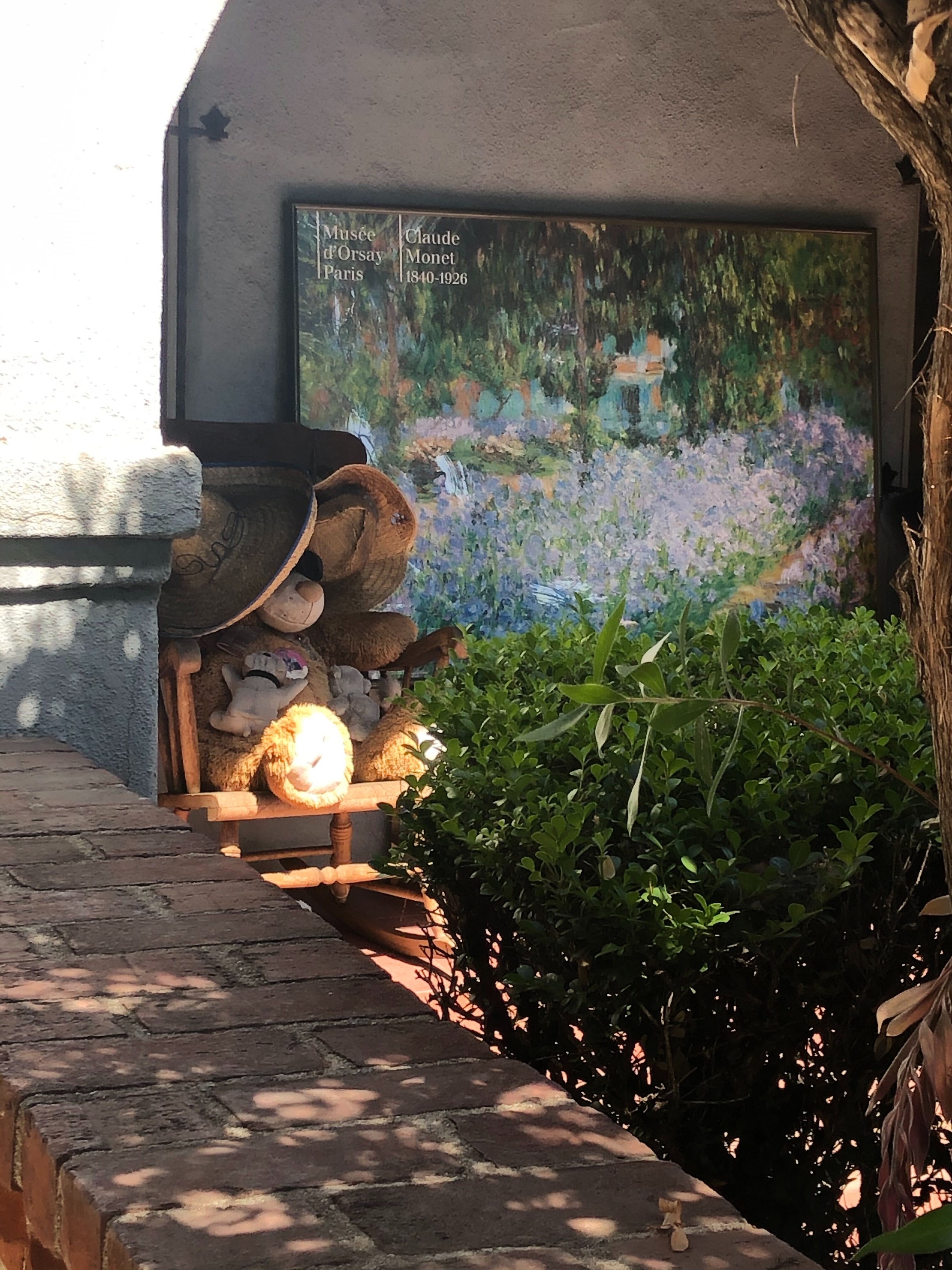 Large stuffed animal sitting on a rocking chair.