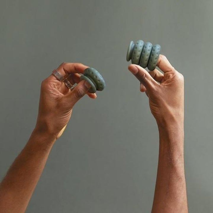 person wing the rings stacked on a finger 