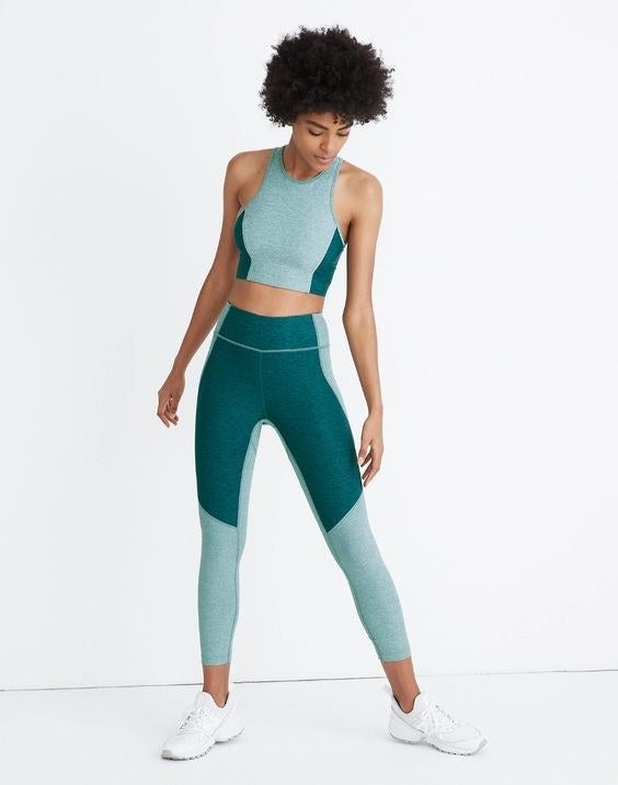 Model wearing the two-toned teal and light green leggings 