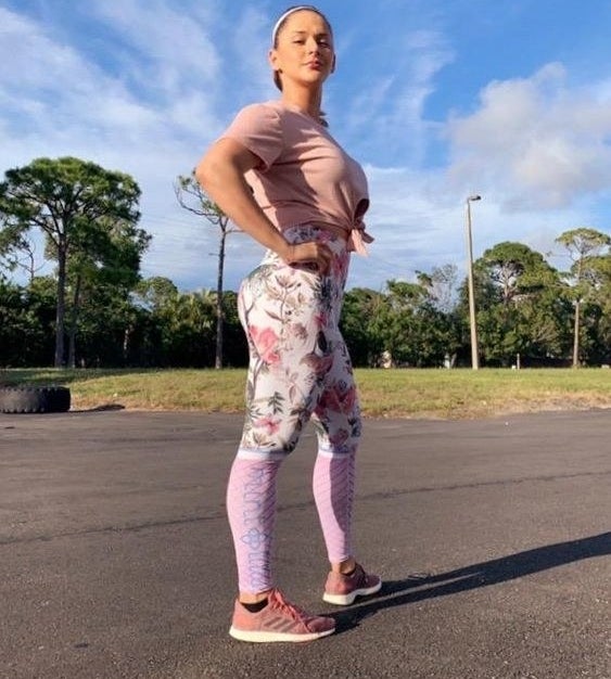 Reviewer wearing the white and light pink floral leggings 