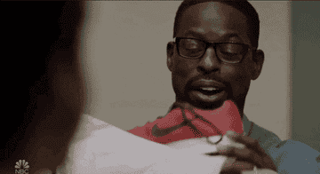 Gif of a character from &quot;This Is Us&quot; opening up sneakers 