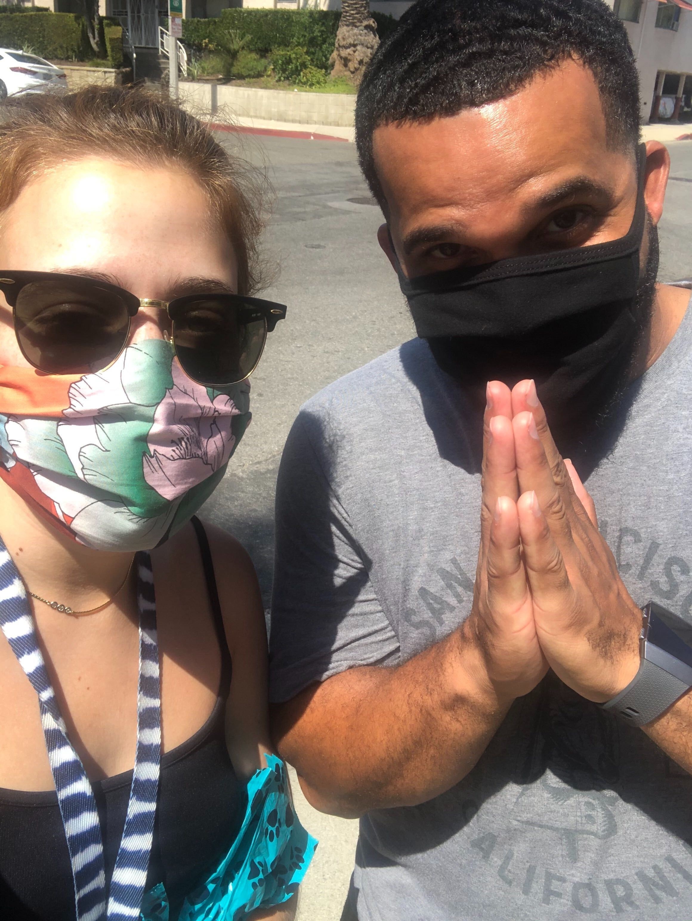 Selfie of Daniella and Troy. Troy is doing prayer hands.