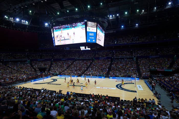 Full stadium of spectators watching netball game