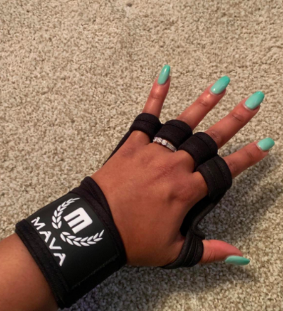 Reviewer wears a black ventilated workout glove that says &quot;Mava&quot; on their hand