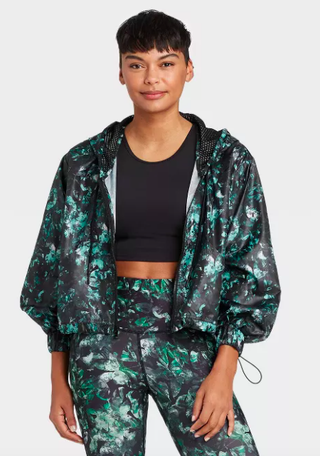 Model wears green and black floral-print activewear jacket with matching leggings