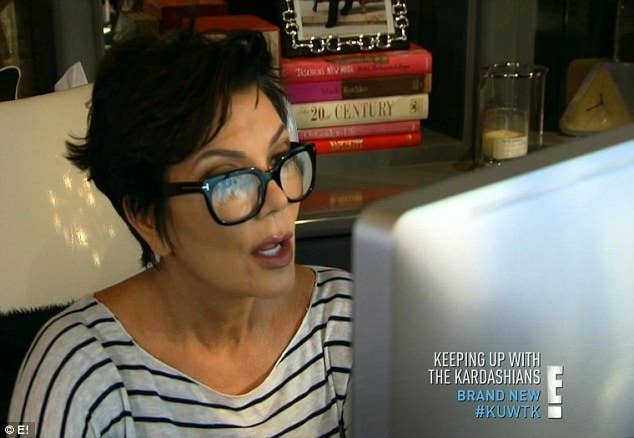 Kris Jenner looking at her computer screen surprised on Keeping Up With The Kardashians