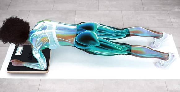 Model uses interactive Plankboard to strengthen their arms, legs, and back