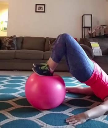 Reviewer shows pink exercise ball in a corner of their living room