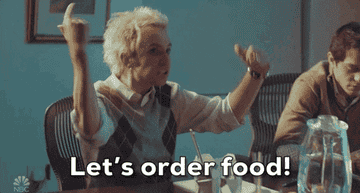 Gif of a character in an SNL sketch saying, &quot;Let&#x27;s order food&quot;